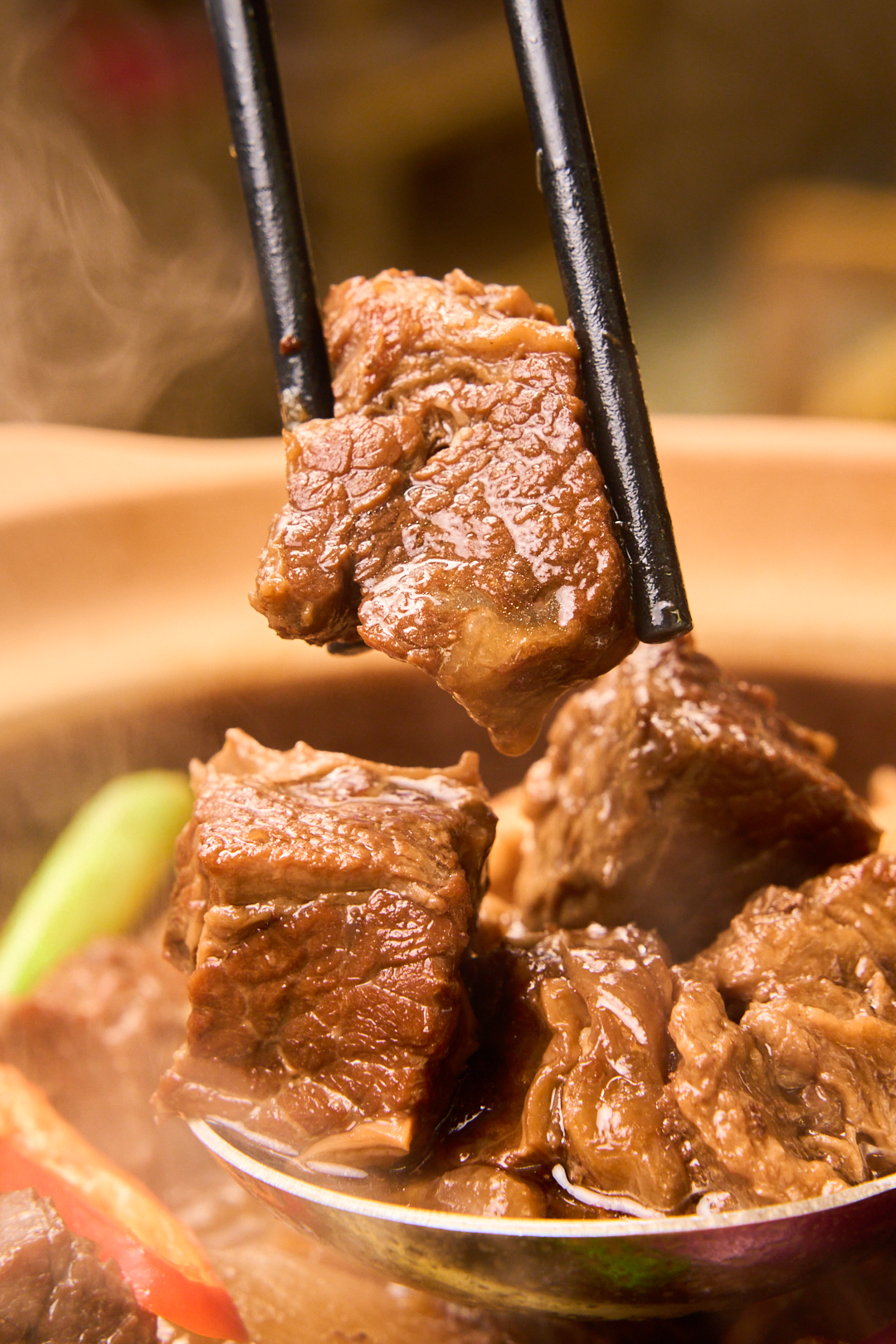 秘制骨汤底一起在砂锅中熬煮,长时间受热熬出腩汁之余,大块的牛腩一直