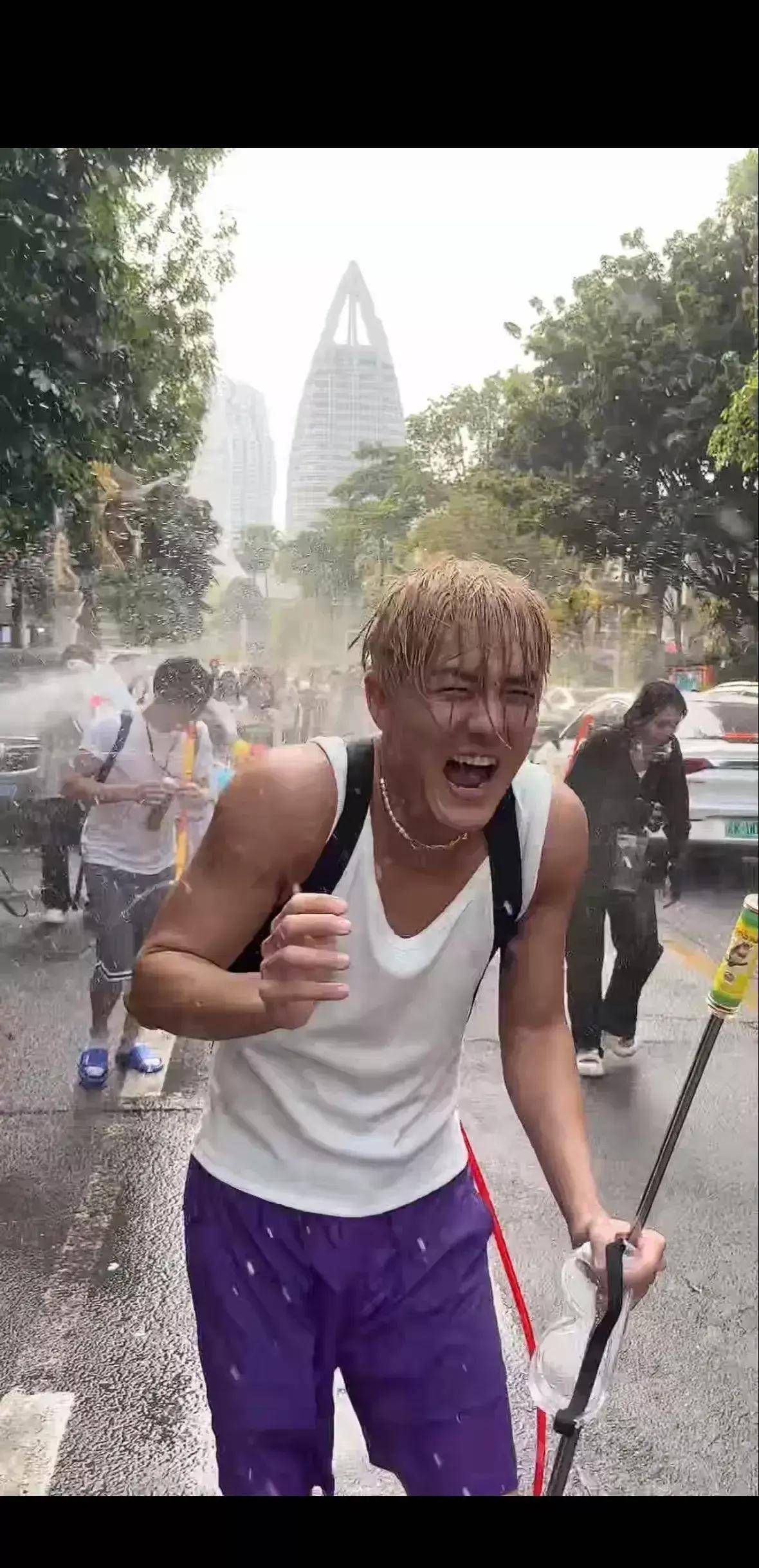 吴克群被"祝福之水"淋湿后,开心地泼洒,玩得很愉快,笑容舒心.