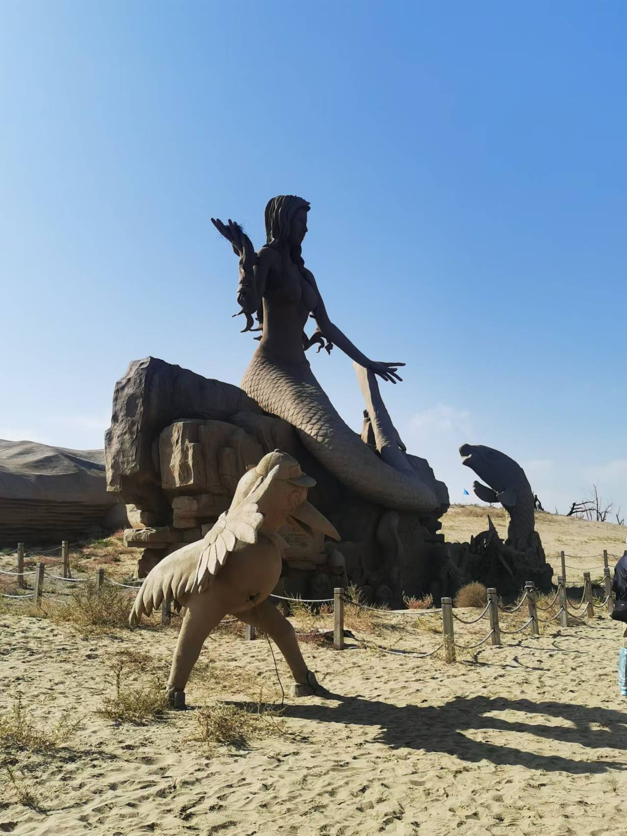 其中最具有代表性的就是一尊美人鱼雕像,沙雕美人鱼姑娘坐在沙湖边