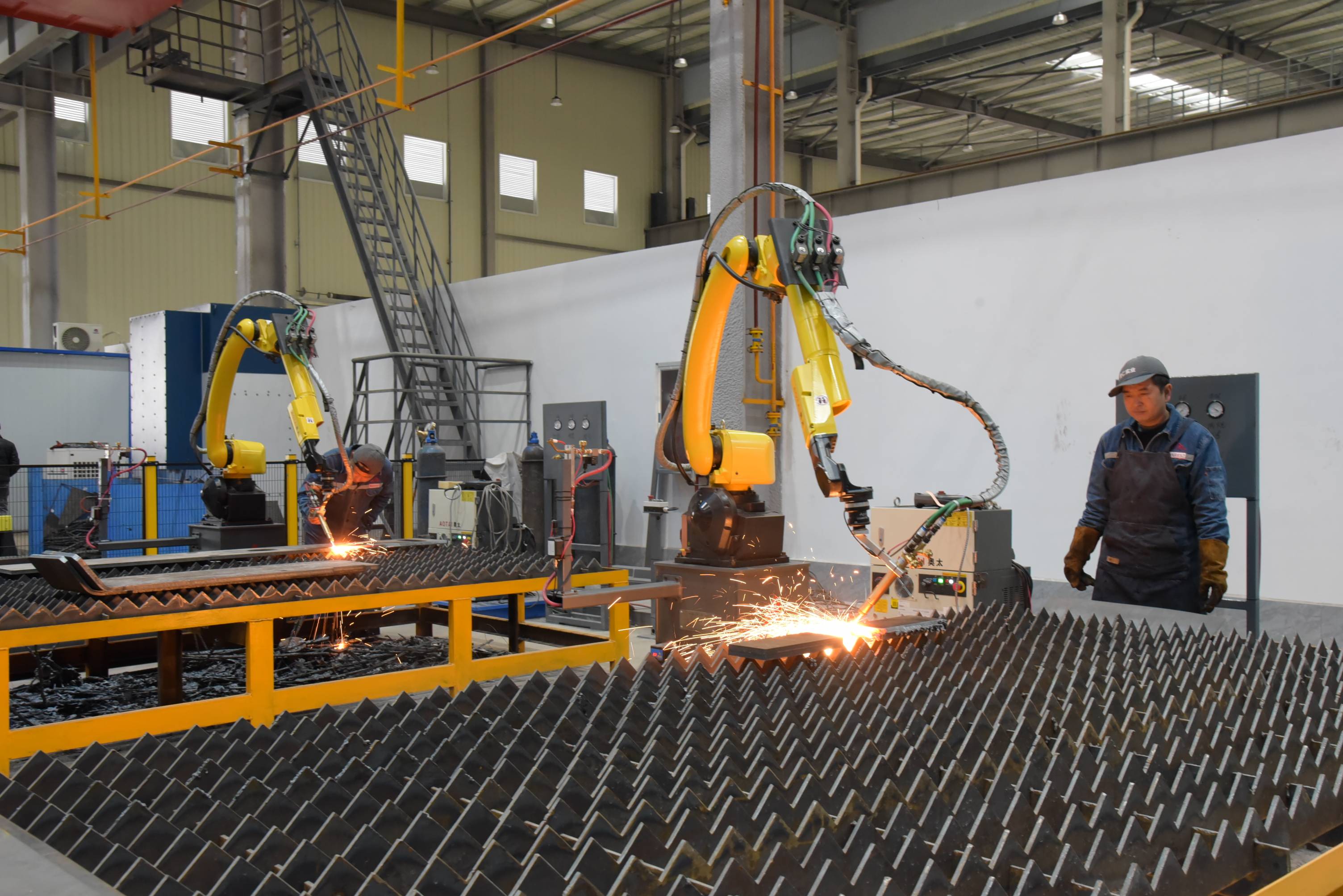 车间内,机声隆隆,繁忙有序,生产入库等工序有序进行,工人们正在熟练地