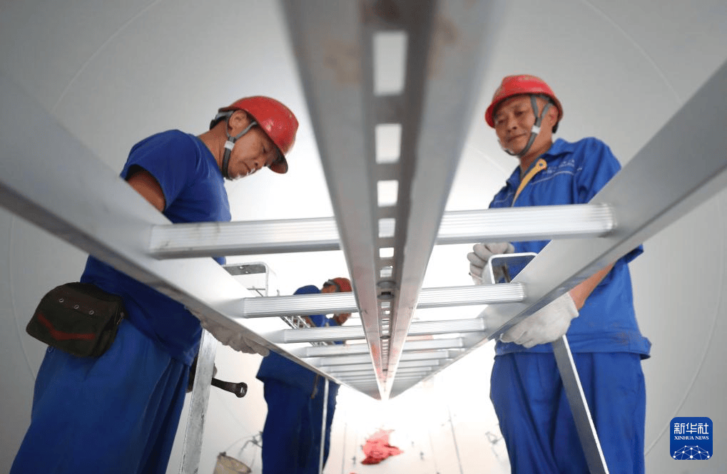 恒岳重钢钢结构工程有限公司的员工在进行风电塔筒装备的外附件安装